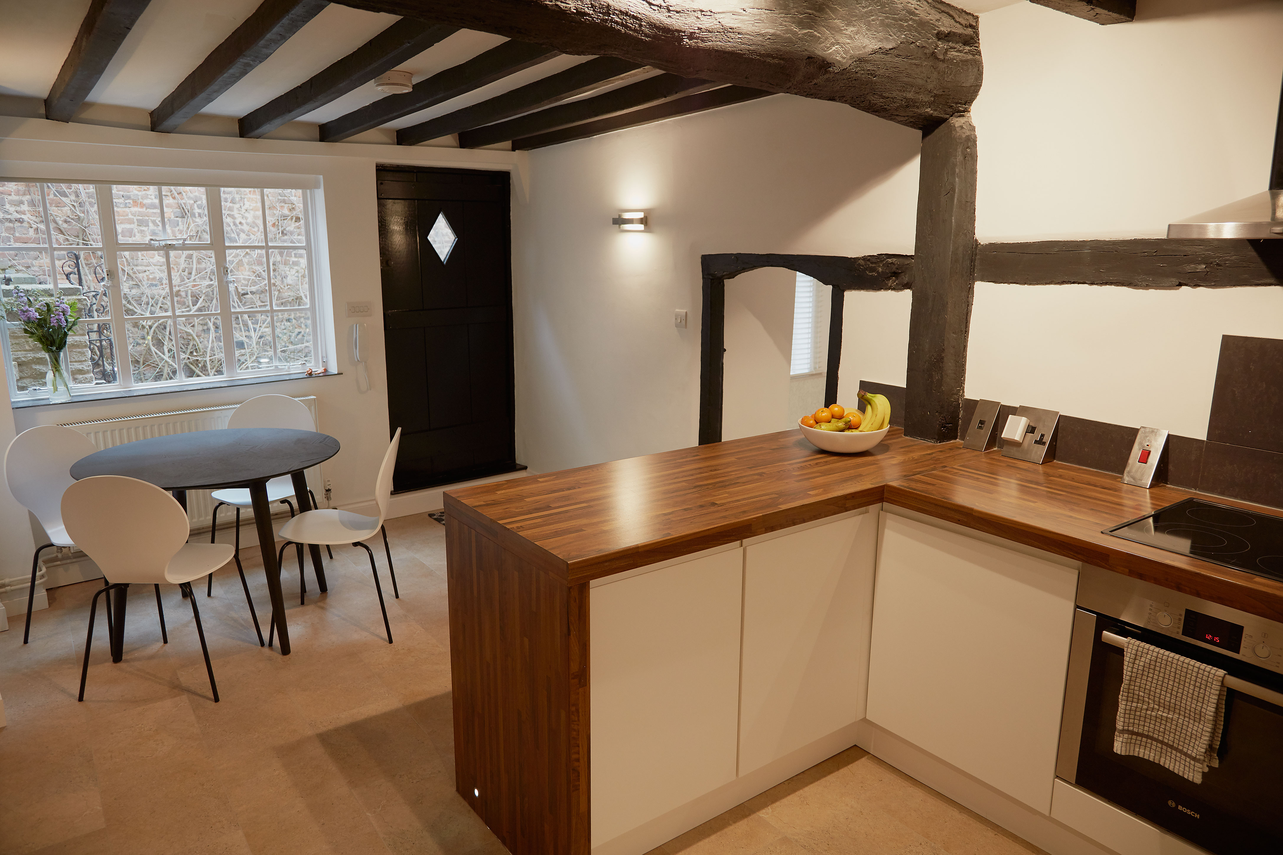 Kitchen-dining with the historic front door and exposed beams